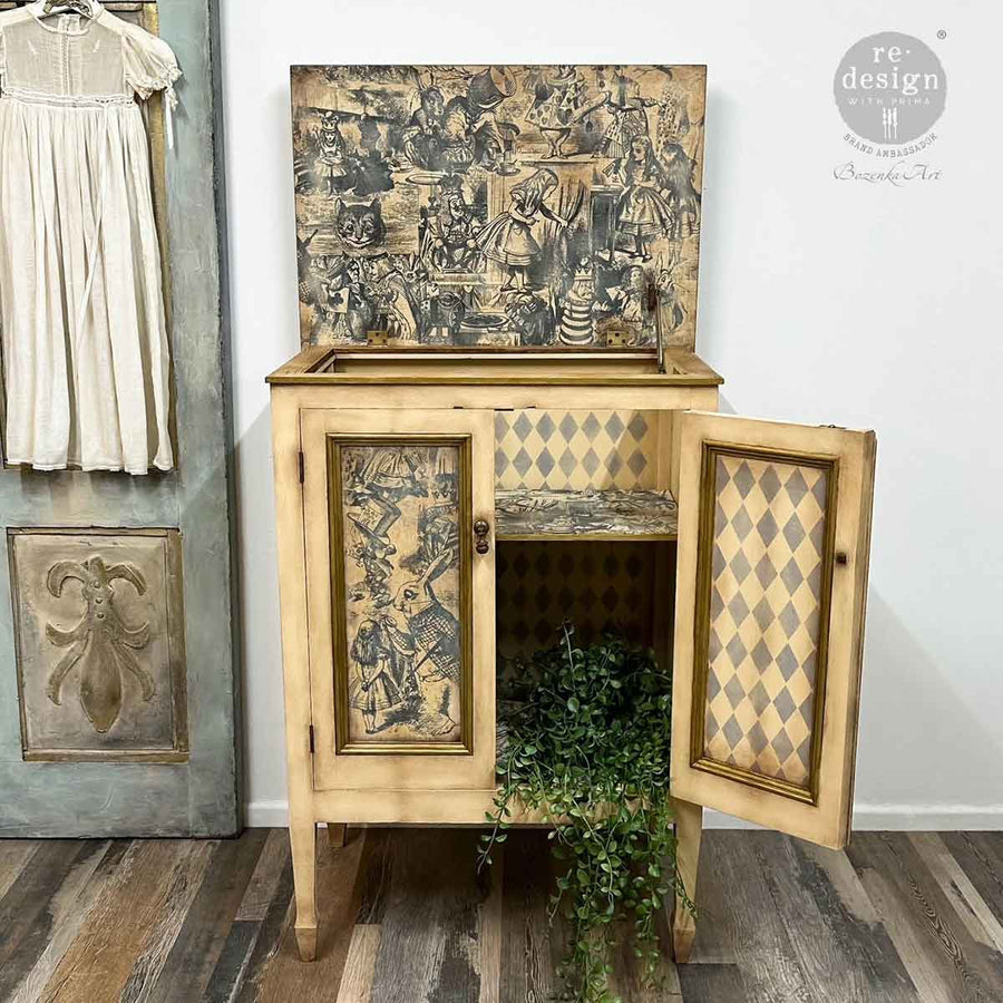 Interior view of a vintage cabinet with Dreaming in Wonderland decoupage on interior lid and door panels, styled with harlequin diamonds.