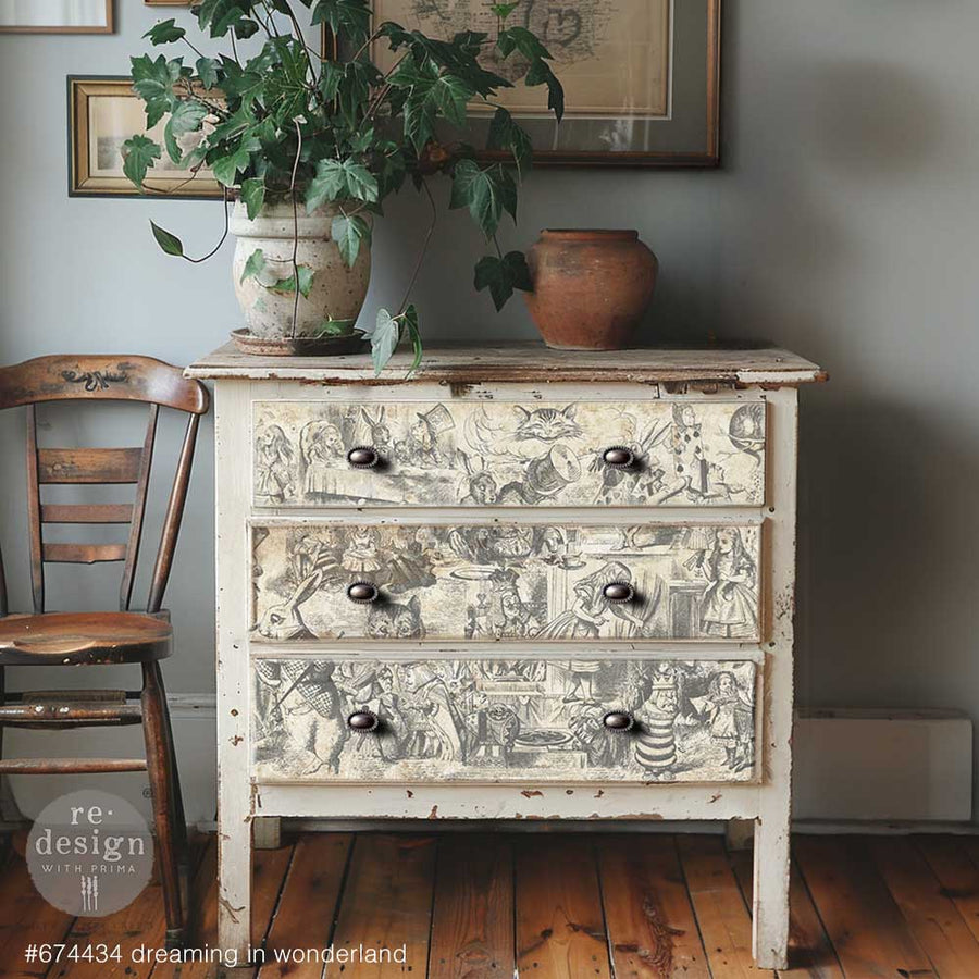 Rustic white dresser with three drawers decoupaged in Dreaming in Wonderland paper, featuring classic Alice in Wonderland scenes.