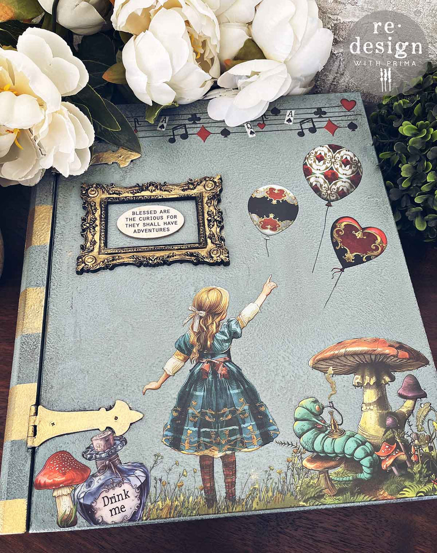Alice in Wonderland decor transfer on a book cover – featuring Alice, mushrooms, and ornate balloon motifs from Redesign with Prima.