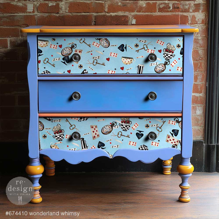 Whimsical blue and yellow painted dresser with Wonderland Whimsy tissue applied to drawer fronts in a vibrant, colorful finish.